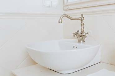 White ceramic sink with vintage style faucets.